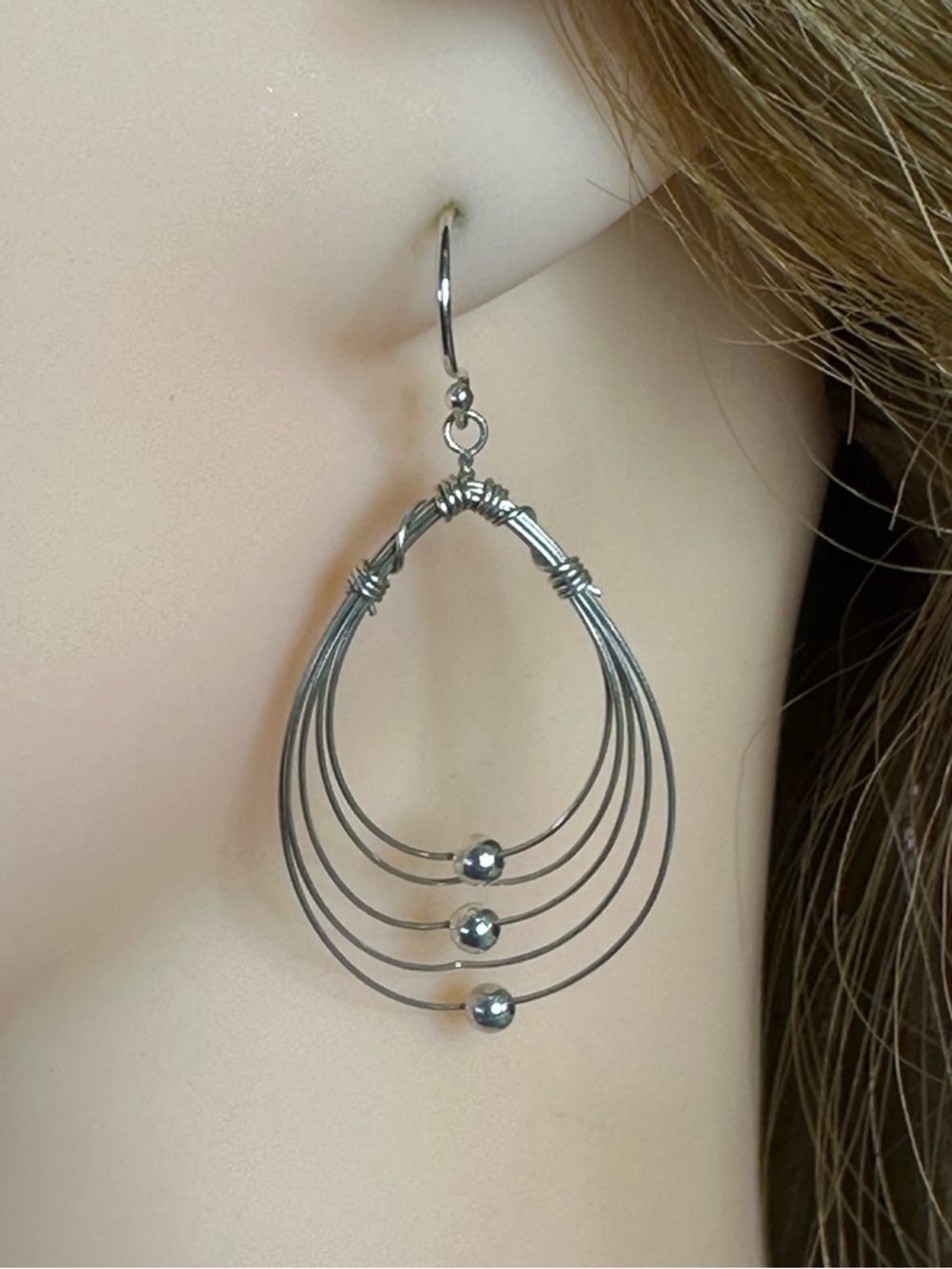 Multi Hoops with moving silver balls dangle earrings.